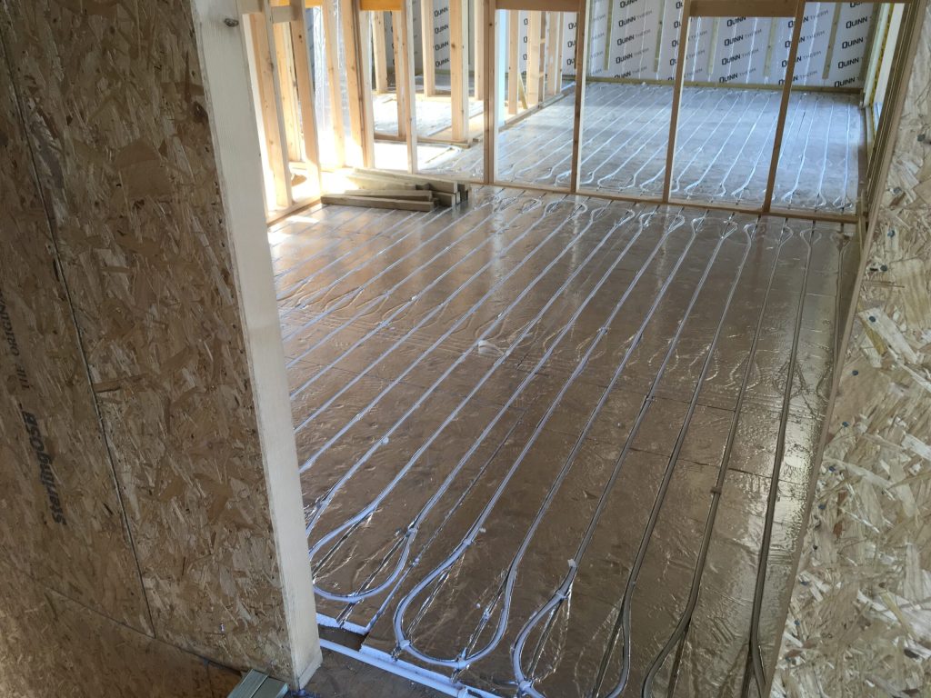 Underfloor heating pipes laid in a timber-frame extension