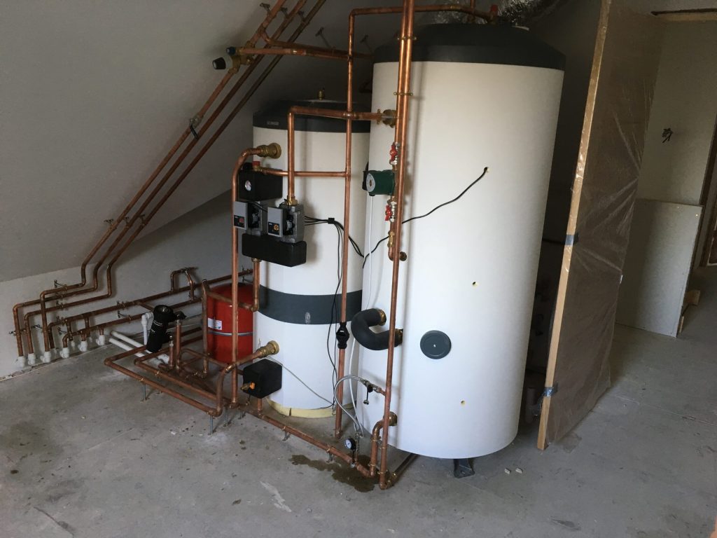 Hot water cylinder and pipework in a plant room