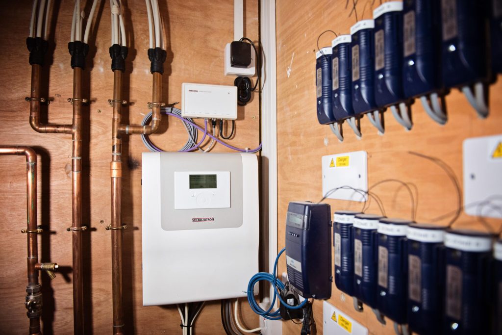 Heating controls and manifold valves on a plant room wall
