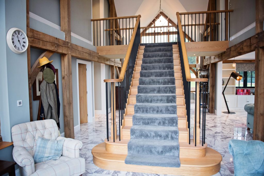 Hallway with a staircase in a converted barn