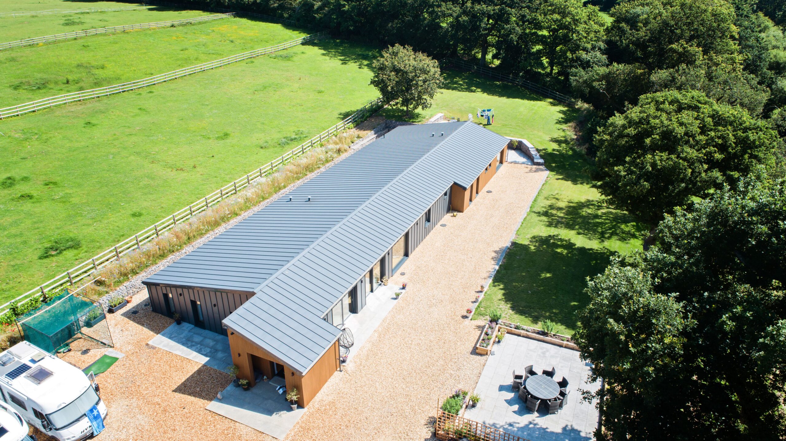 Aerial view of a single-storey barn conversion in the countryside