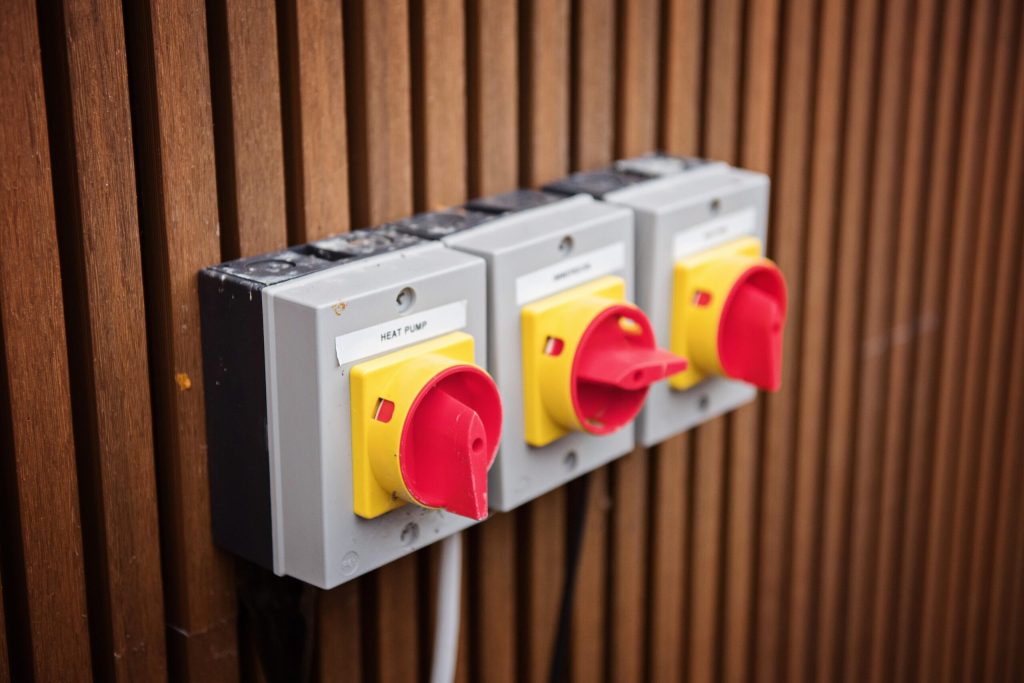 Electrical isolator switches mounted on timber cladding