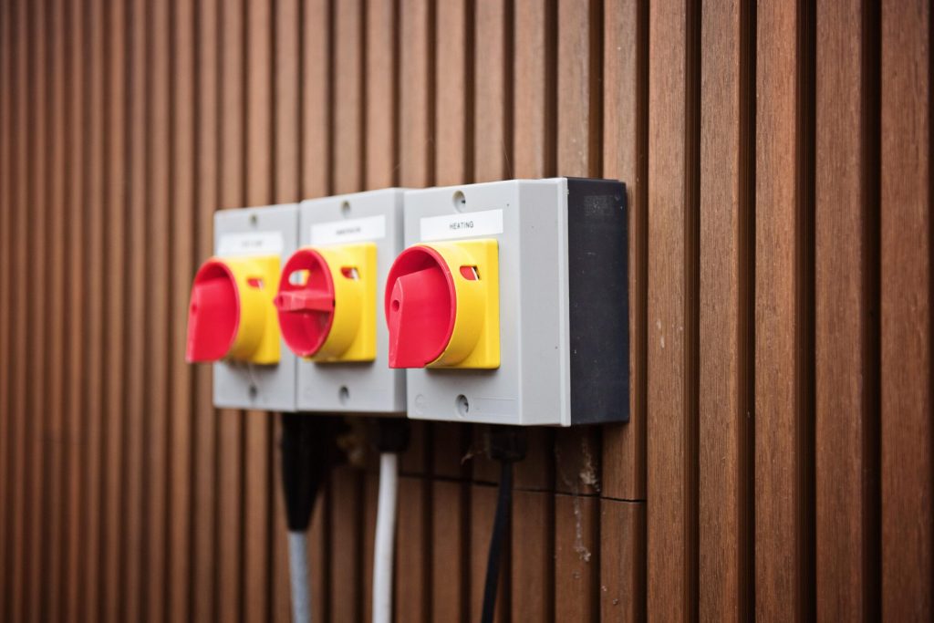 Electrical isolator switches mounted on timber cladding
