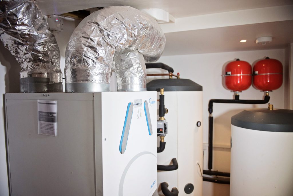Plant room with ventilation ducting and a hot water cylinder