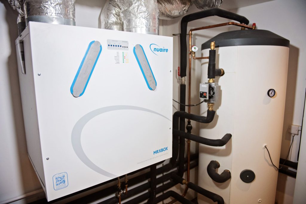 MVHR ventilation unit and hot water cylinder in a plant room