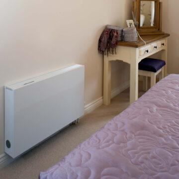 An energy efficient radiator is shown in a bedroom
