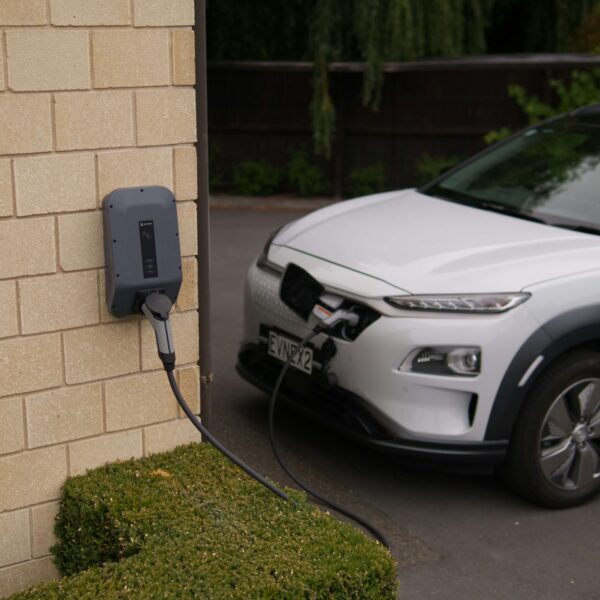An electric car is pictured charging from a domestic charge point
