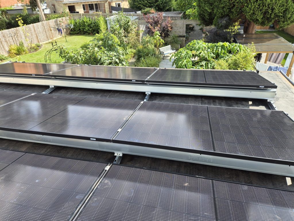 Solar panels installed on a flat roof above a garden