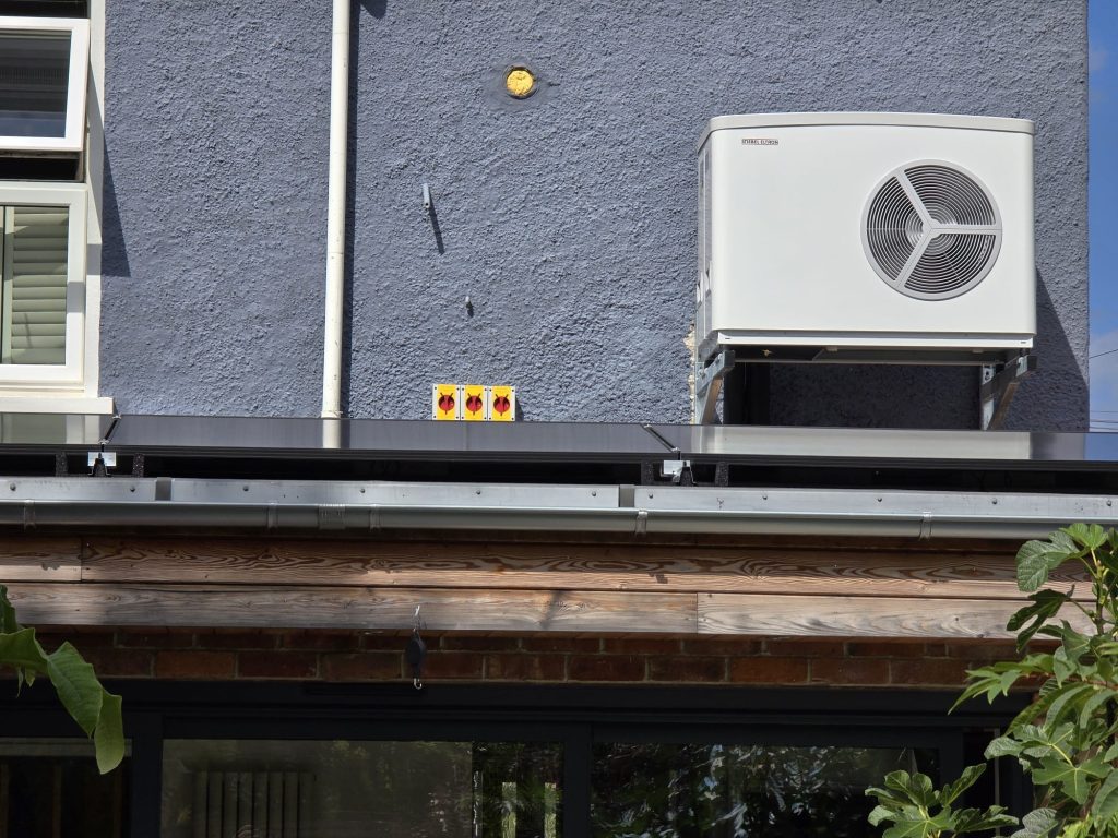 Heat pump mounted above flat roof