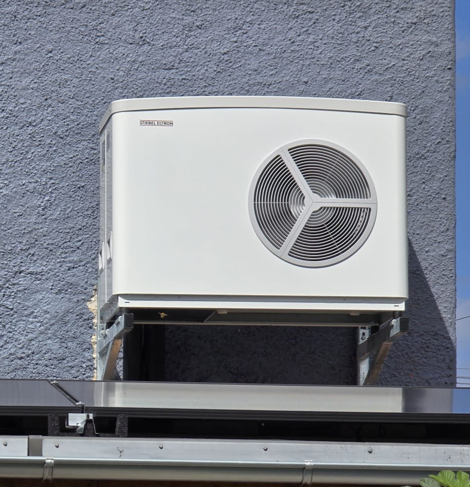 Air source heat pump mounted on a wall bracket