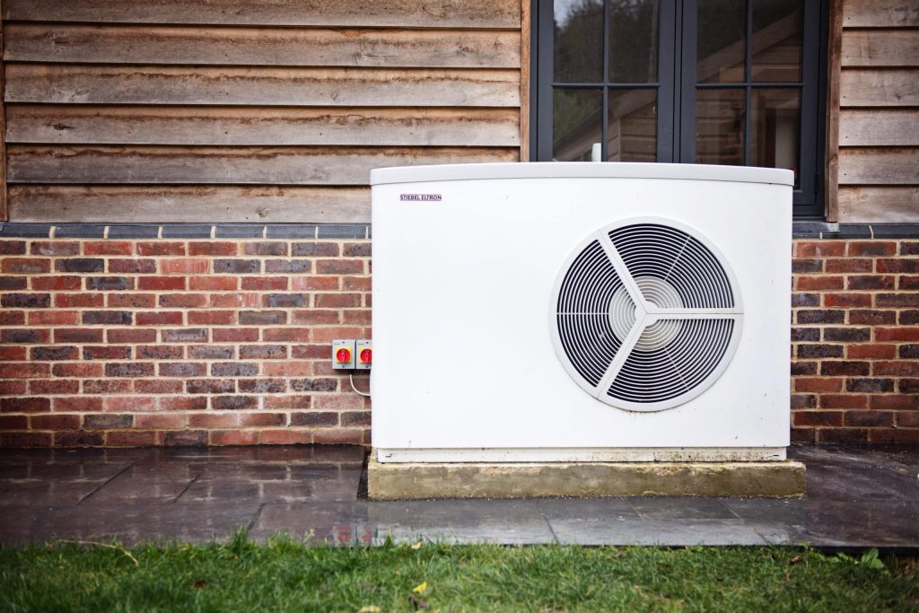 Stiebel Eltron air source heat pump installed beside a timber-clad home
