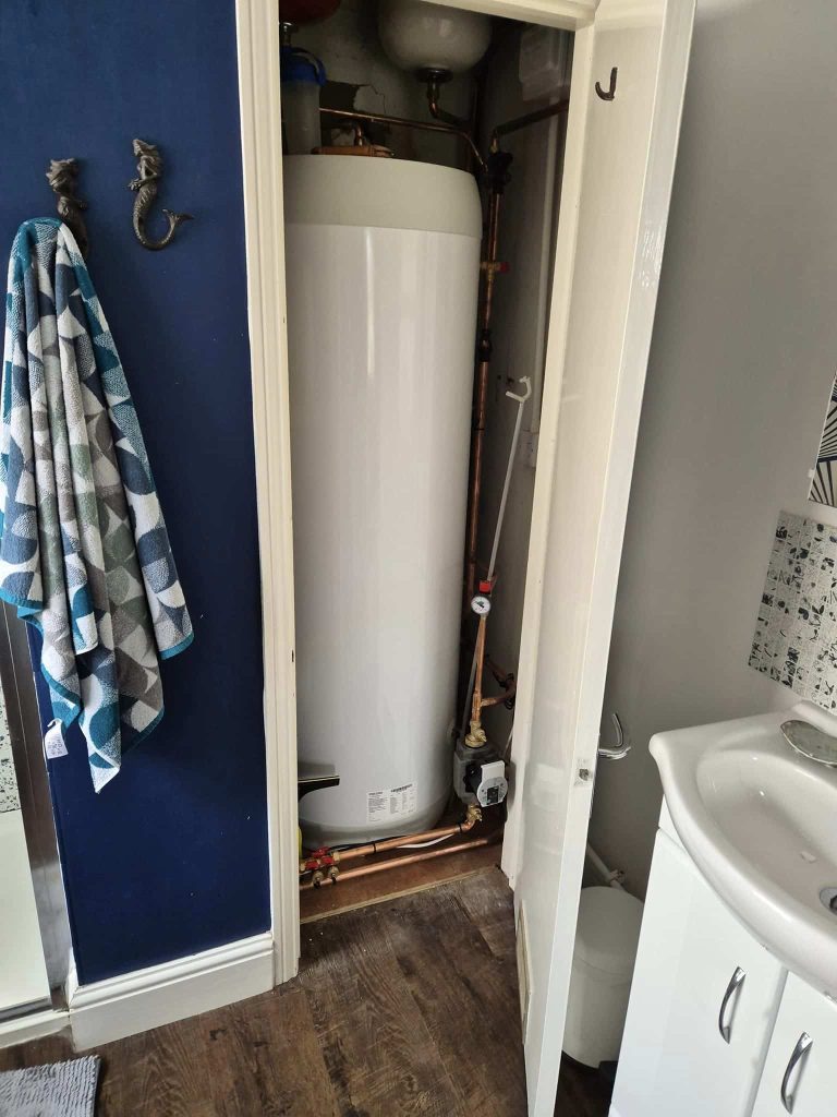 cylinder inside an existing bathroom cupboard