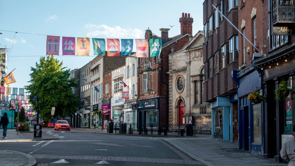 Town high street with shops and bunting